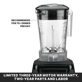 A close-up of a heavy duty blender with a clear, BPA free pitcher and black lid, labeled recommended for 75+ drinks per day. At the bottom, bold text reads: Limited three-year motor warranty, two-year parts and labor.