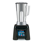 A heavy duty commercial blender with a tall stainless steel container, clear lid, and side handle sits on a black base. The digital control panel is labeled "Xtreme" and "Waring Commercial." The background is plain white.