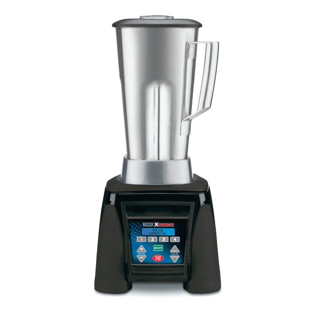 A heavy duty commercial blender with a tall stainless steel container, clear lid, and side handle sits on a black base. The digital control panel is labeled "Xtreme" and "Waring Commercial." The background is plain white.