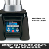 Close-up of a heavy duty blender base with a digital control panel showing buttons numbered 1 to 4, labeled “4 Programmable Beverage Stations.” Compatible with a stainless steel container, it features a three-year limited motor warranty banner below.