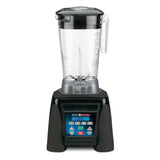 A high-power commercial blender with a clear, 64 oz pitcher, sturdy handle, and lid sits atop a black base. The base features a blue digital control panel with multiple buttons, symbols, and a small screen for versatile blending settings.