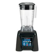 A high-power commercial blender with a clear, 64 oz pitcher, sturdy handle, and lid sits atop a black base. The base features a blue digital control panel with multiple buttons, symbols, and a small screen for versatile blending settings.