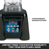 Close-up of a 64 oz Commercial Blender base showing a digital control panel labeled “Waring Xtreme” with buttons for 4 programmable beverage stations, speed, pulse, on/off, and start/stop. Text below: "Limited three-year motor warranty, two-year parts and labor.