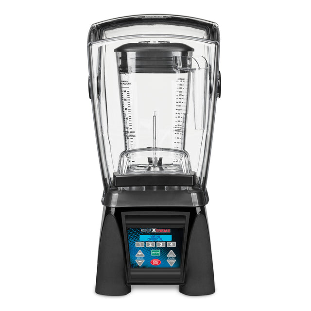 A high-power blender with a clear sound enclosure, a large transparent blending jar with measurement markings, black base, and a digital touchpad featuring blue and red buttons labeled for various blending functions.