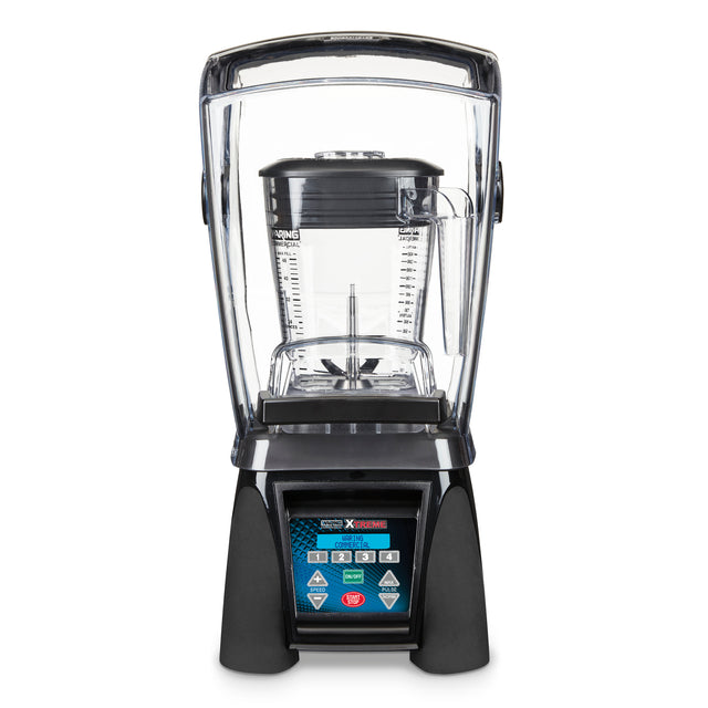 A high-power commercial blender with a clear sound enclosure, large measurement-marked pitcher, black base, and digital control panel with multiple buttons and display screen, shown against a plain white background.