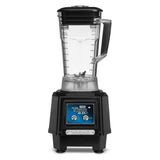 A black countertop blender with a clear 64 oz pitcher, measurement markings, and handle sits on a sturdy base. The base features two metal control dials and a blue “Torq 2.0” label. Four metal blades are visible at the bottom of the bar blender.