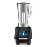 A commercial TORQ 2.0 Series Blender with a tall, stainless steel container and handle sits atop a sturdy black base. The blue control panel features a large central dial labeled TORQ 2.0 and the brand name WARING below it.