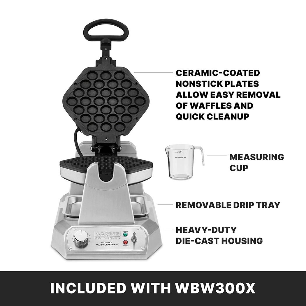 A silver bubble waffle maker with honeycomb-patterned non-stick plates is open. Labeled features include non-stick plates, a measuring cup, removable drip tray, and heavy-duty die cast housing. Text below reads “Included with WBW300X.”.
