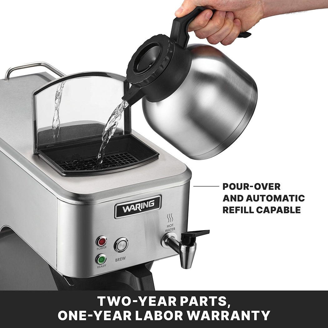 A hand pours water from a metal carafe into a Waring commercial coffee maker. The lid is open, with “Ready” and “Brew” lights visible. Text reads: “POUR-OVER AND AUTOMATIC REFILL CAPABLE” and “TWO-YEAR PARTS, ONE-YEAR LABOR WARRANTY.”.