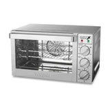 A stainless steel Waring WCO250X countertop oven with a glass front door, three control knobs for function, temperature, and timer, indicator lights, two wire racks, and a baking tray. The brand “Waring” is embossed on the front panel.
