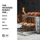 A Waring WCO250X commercial convection oven with a tray of baked scones inside and golden croissants on top sits on a marble counter. Text on the left reads: The WCO250X is built for... roasts, pizzas, pies, breads and more. UL and NSF logos are below.