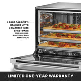 A stainless steel countertop oven with its door open, showing three racks inside, each holding a quarter-size sheet pan with pizza. Text on the image highlights the commercial convection oven’s large capacity and a limited one-year warranty at the bottom.