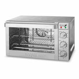 A stainless steel countertop convection oven with a glass door, two wire racks inside, and three control dials on the right for function, temperature, and timer. Indicator lights are above the dials. The brand Waring is visible on the lower front.