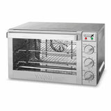 A stainless steel Commercial Convection Oven with a glass door, three control dials for function, temperature, and timer on the right side, indicator lights above the dials, and two wire racks inside. The Waring brand appears on the front.