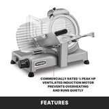 A Waring Commercial Food Slicer sits on a gray surface, featuring a clear guard and adjustable slice thickness knob. This electric food slicer’s ¾ peak HP ventilated induction motor prevents overheating and ensures quiet operation.