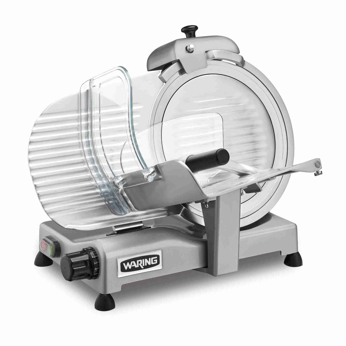 A silver Waring Commercial Food Slicer with a heavy duty 12" tempered chrome blade, clear plastic guard, thickness adjustment knob, and a metal food carriage on a sturdy gray base with non-slip feet. Clean and set against a white background.
