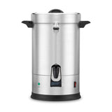 A large stainless steel Coffee Urn with a dual heater system, black handles, a clear water level gauge, front spout for dispensing, indicator lights with a red switch below. The urn features a rounded lid and sits on a black base.