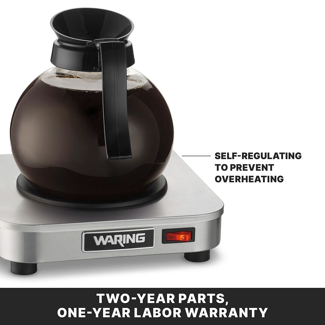 A glass coffee carafe filled with coffee sits on a stainless steel single burner Waring coffee warmer. Text points to the carafe, stating Self-regulating to prevent overheating. Below, a label reads, Two-year parts, one-year labor warranty.