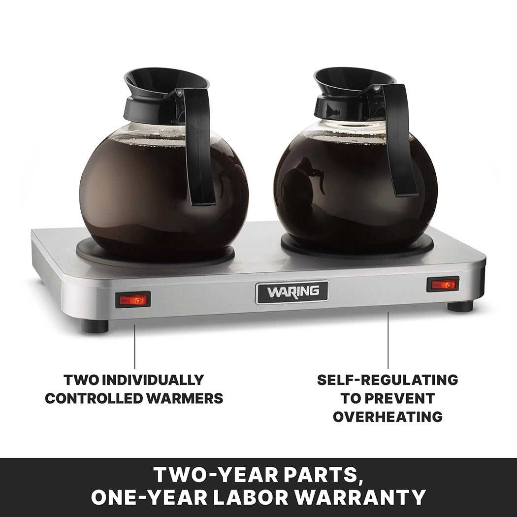 Two glass coffee decanters filled with coffee sit on a stainless steel Waring coffee warmer featuring double burner plates. Labels highlight two individually controlled warmers on the left and self-regulating to prevent overheating on the right. Warranty text below.