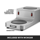 A stainless steel Café Deco Coffee Warmer features two round heating plates labeled “LOWER” and “UPPER” with red on/off switches. Durable wipe-clean stainless steel construction and nonskid feet ensure stability. Included with WCW20R double burner.