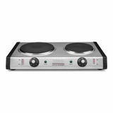 A heavy-duty stainless steel double electric cooktop with two black cast iron burner plates, control knobs for each burner, indicator lights, and Waring Professional Extra Burner printed on the front. Features black sides and a rectangular shape.