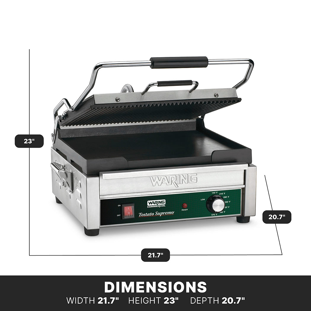 A stainless steel panini grill with a ribbed upper plate and flat lower surface is shown open. The front features a green control panel with knobs and switches. Dimensions are labeled: width 21.7, height 23, depth 20.7.