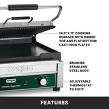A commercial stainless steel panini grill featuring a ribbed top, flat bottom plate, control knob, 14.5x11 cooking surface, and adjustable thermostat to 570°F. This electric panini grill offers durability with a brushed stainless steel body.