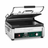A stainless steel electric panini grill with a ridged top plate, flat bottom plate, black handle, and green control panel labeled “Tostato Supremo.” The open Dual Surface Panini Grill features adjustable thermostats and a programmable on/off dial.