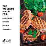 A top view of three grilled panini sandwiches with grill marks, filled with meat and vegetables, garnished with cilantro and cherry tomato halves on a wooden surface. Perfectly prepared using an electric panini grill with adjustable thermostats for ideal results.