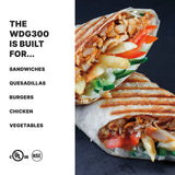 Close-up of a grilled wrap cut in half, revealing chicken, fries, sliced vegetables, and sauce. Text on the left lists: “The WDG300 Commercial Panini Grill is built for... Sandwiches, Quesadillas, Burgers.” Two certification logos are below.