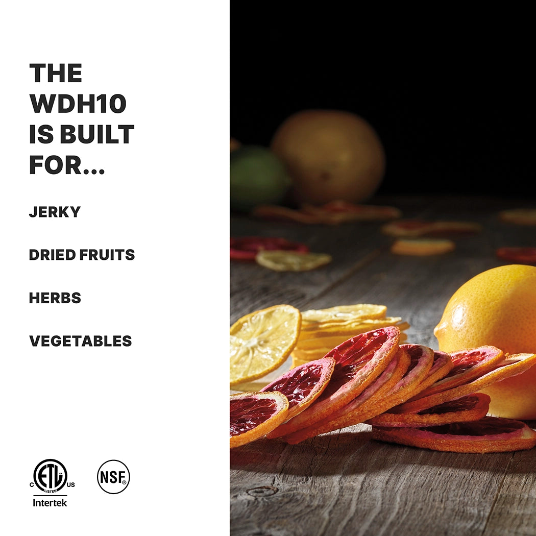 A wooden surface displays dried citrus slices, whole citrus fruits, and herbs. On the left, bold text reads: The WDH10 dehydrator is built for... Jerky, Dried Fruits, Herbs, Vegetables. Certification logos appear at the bottom left.