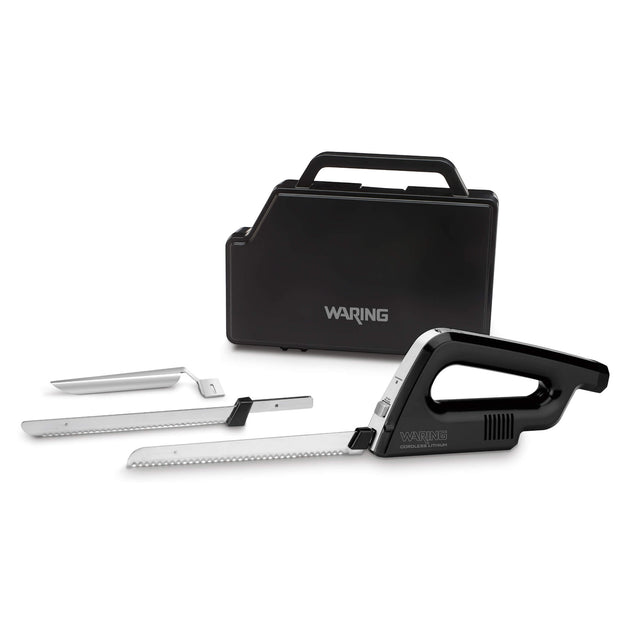 A black and silver electric carving knife set with two serrated blades, a carving fork, and a black carrying case labeled Waring. The knife handle and blades are arranged in front of the closed case on a white background.