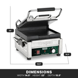A Compact Toasting Grill with cast iron plates, this stainless steel panini press features a black handle and green control panel. Dimensions: width 14.5, height 22, depth 15.5. The panel includes indicator lights and an adjustable thermostat.