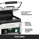 A Waring Compact Toasting Grill with 9.75 x 9.25 cast iron plates, brushed stainless steel body, and adjustable thermostats up to 570°F is shown with labeled features. The hinged lid is open, revealing the cooking surface.