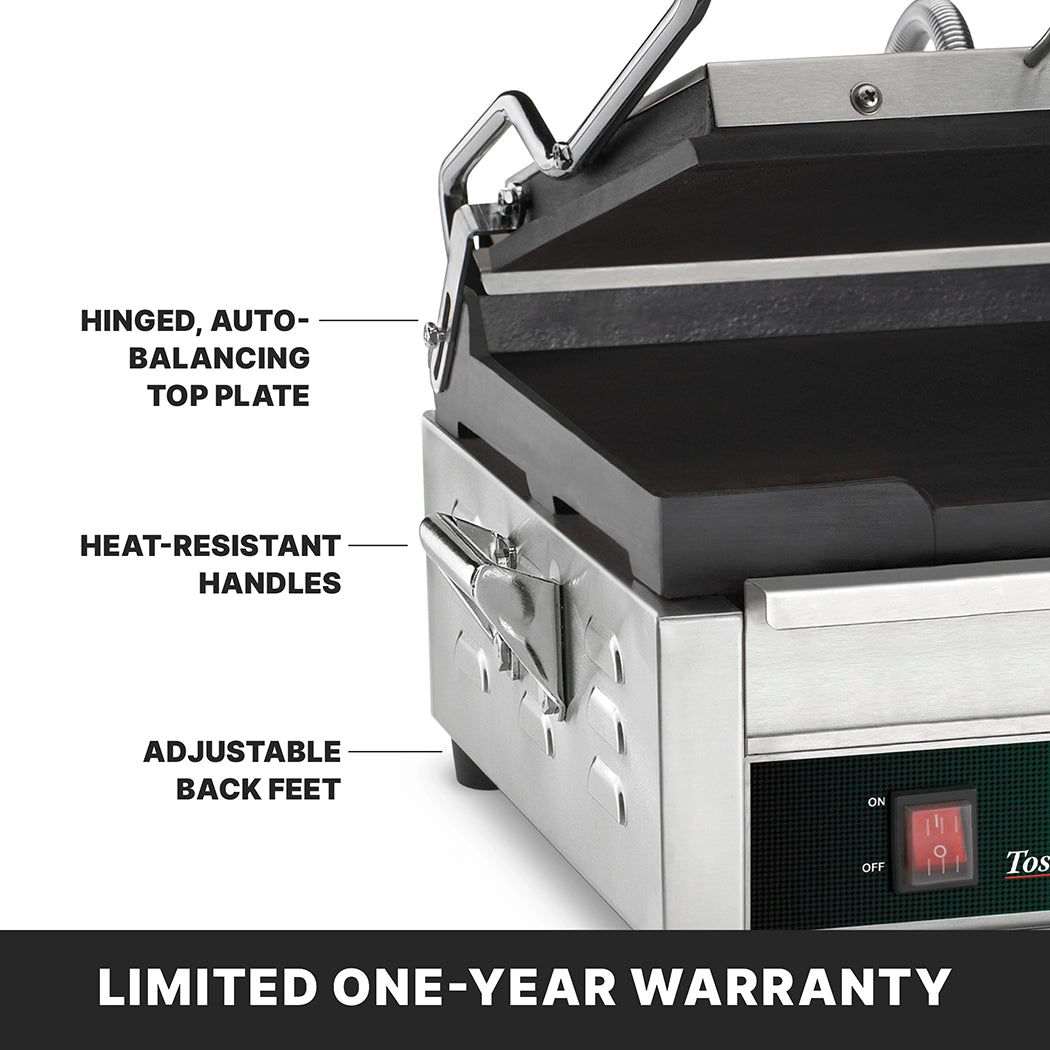 Close-up of a stainless steel toasting grill with flat cast iron plates, showing labels for its hinged, auto-balancing top plate, heat-resistant handles, adjustable back feet, and control panel with switch. Text at the bottom reads LIMITED ONE-YEAR WARRANTY.