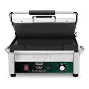 A stainless steel Waring commercial Panini Grill with a black handle, nonstick grill plates, control knob labeled “low” to “high,” red power switch, indicator lights, and the label Tostato Supremo on the front panel. The lid is open.