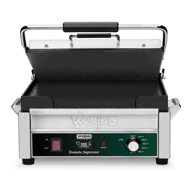 A stainless steel Waring commercial Panini Grill with a black handle, nonstick grill plates, control knob labeled “low” to “high,” red power switch, indicator lights, and the label Tostato Supremo on the front panel. The lid is open.