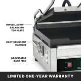 A close-up of a stainless steel Panini Grill with labeled features: hinged, auto-balancing top plate, heat-resistant handles, adjustable back feet, and a cast iron cooking surface. The bottom shows a power switch and LIMITED ONE-YEAR WARRANTY.