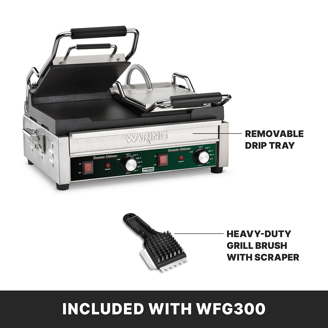 A stainless steel Waring panini press with labeled features: adjustable thermostats, a removable drip tray, and a heavy-duty grill brush with scraper, shown below the press. The Dual Toasting Grill includes flat cast iron plates and has black handles and control knobs.