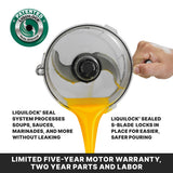 A close-up of a batch bowl food processor with an S-blade and patented LiquiLock seal pours orange liquid smoothly. Text highlights leak-proof processing and secure blade. A hand steadies the bowl. Banner states warranty details.