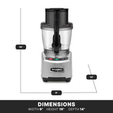 A heavy duty gray Waring food processor is shown front-facing. It features a clear bowl with LiquiLock seal system, black lid and handle, and three colored buttons. Dimensions: 19"H x 9"W x 14"D. The base has a Waring logo and sits on a black DIMENSIONS-labeled surface.