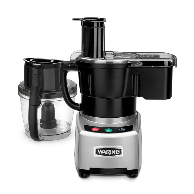 A Waring Food Processor with a silver base, black controls, and a clear plastic bowl featuring the LiquiLock seal system. The bowl has a black handle, a wide feed chute lid, and three colored control buttons—red, green, and blue—on the front.