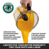 A hand pours thick orange soup from a Food Processor bowl with an S-blade. Text highlights the LiquiLock seal system, preventing leaks and making pouring easy. A seal badge and warranty details are also visible on the image.