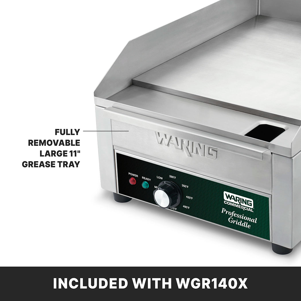 A stainless steel Waring countertop electric griddle features labeled control knobs, indicator lights, and a fully removable large 11-inch grease tray. The “Professional Griddle” label and “INCLUDED WITH WGR140X.” appear below its 14" x 16" cooking surface.