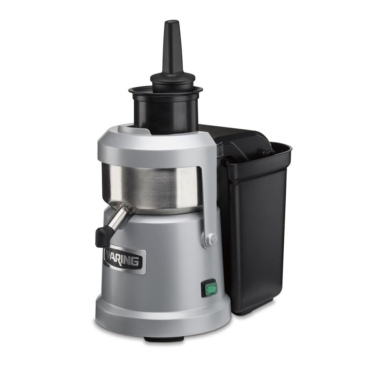 A silver and black heavy duty Juice Extractor with a cylindrical metal body, vertical black feed chute, side spout, and large black pulp container on the right. “Waring” is on the front, with a green power switch and continuous pulp ejection system.