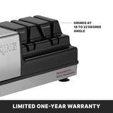 Close-up of a black and silver electric Knife Sharpener with labeled slots for fine and coarse grinding wheels. Text shows it sharpens at an 18 to 22 degree angle. A bold bottom banner states “Limited One-Year Warranty” on a dark background.