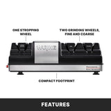 An electric Knife Sharpener with a compact footprint, featuring one stropping wheel on the left and two grinding wheels—fine and coarse—on the right. Sleek black with a silver center and Waring logo.