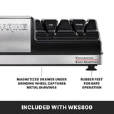 Close-up of the electric Waring Knife Sharpener showing “Fine” and “Coarse” grinding wheels, a magnetized drawer for metal shavings, and rubber feet for stability. Features are detailed with “Included with WKS800” at the bottom.
