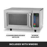 A stainless steel microwave oven with a digital keypad and display showing 2:30. Arrows point to its cleanable air filter and interior oven light. This medium duty, 1000 watts model includes a sturdy handle and sits on black feet. INCLUDED WITH WM090.