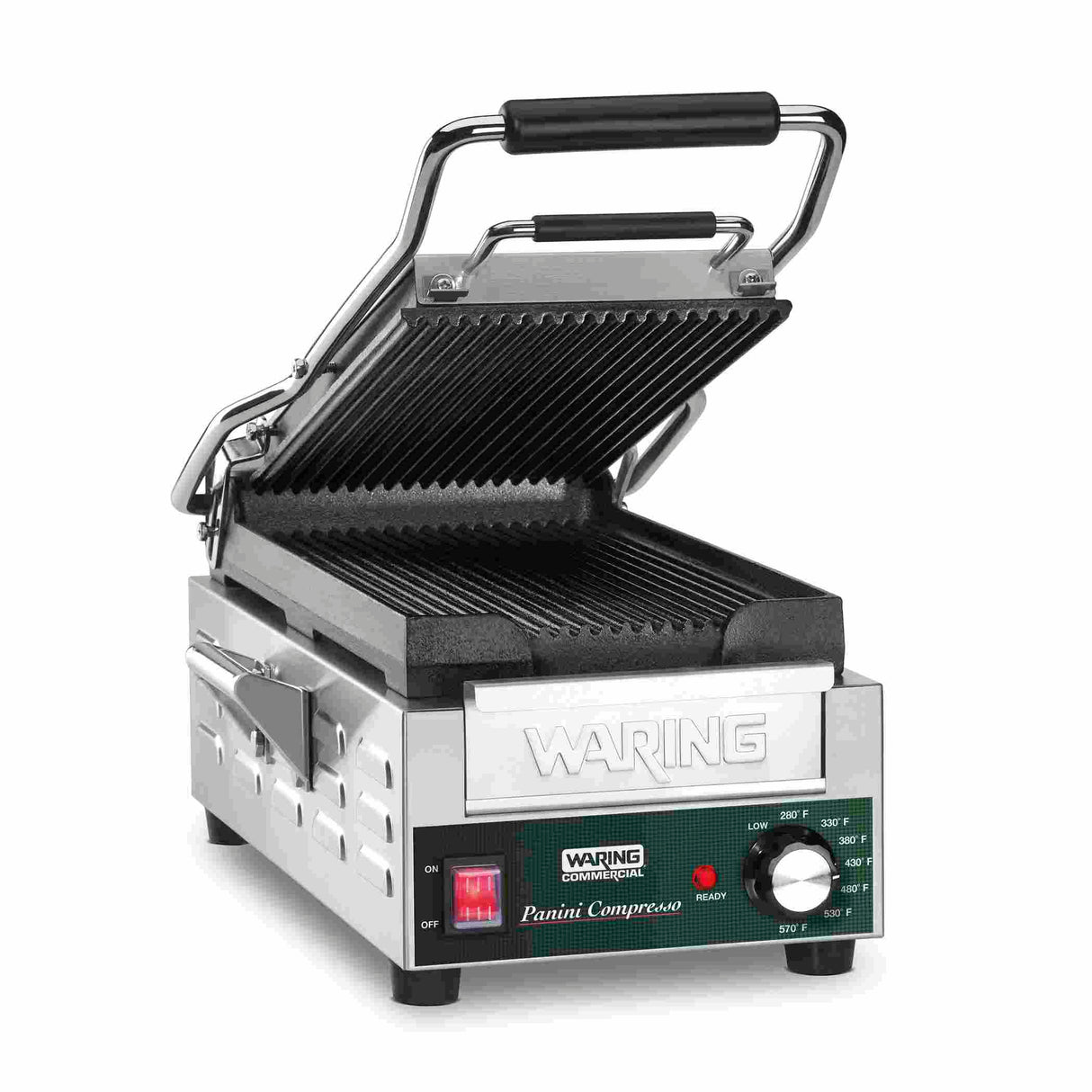 A stainless steel panini grill with ribbed cast iron plates and a ridged top plate lifted open. The control panel features a red power switch, ready light, adjustable thermostat, and the WARING brand above. Black handles rest on a white surface.